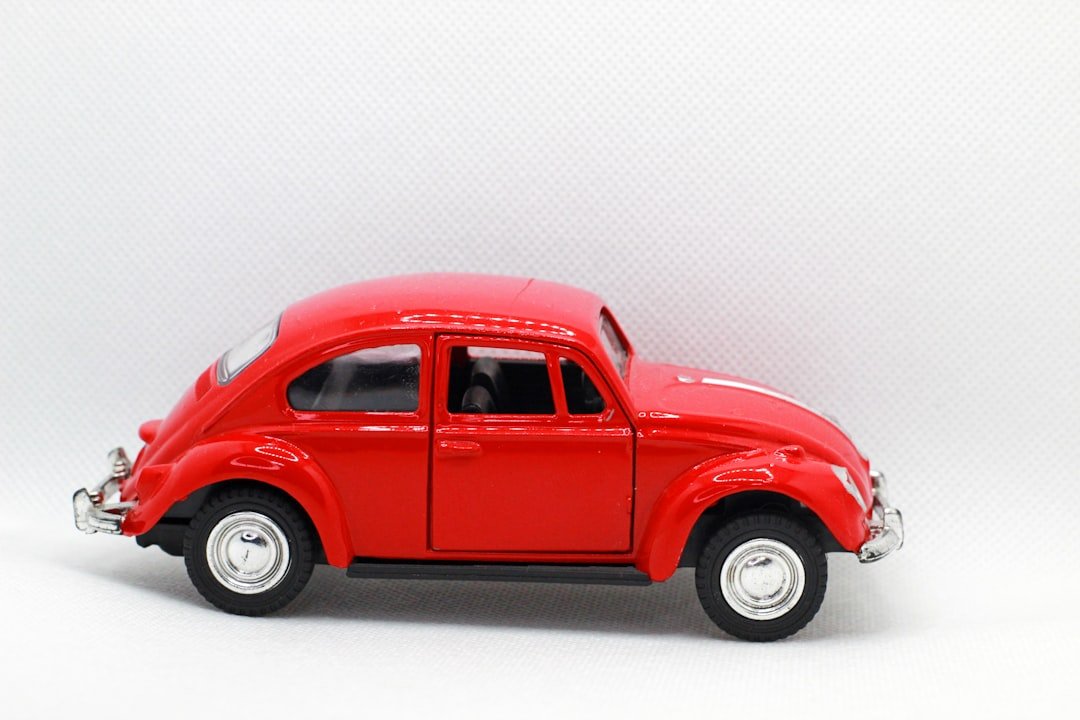 a red toy car on a white background