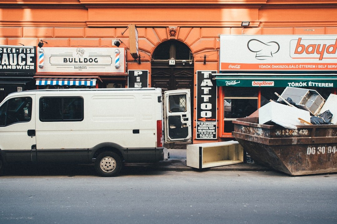 a white van parked in front of a building