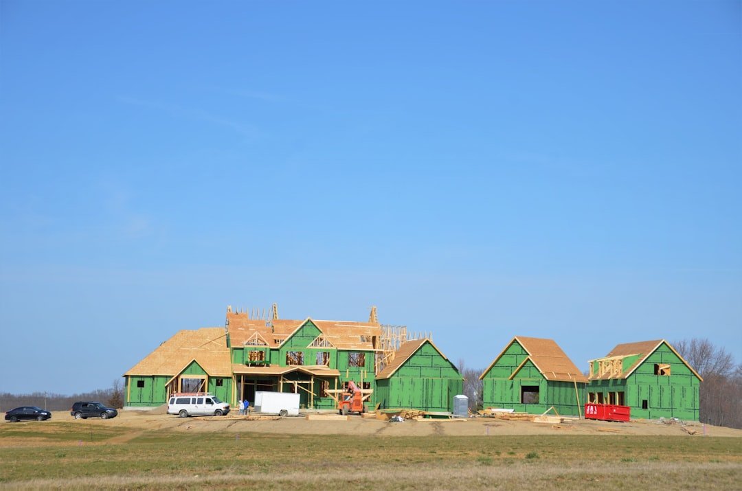 a green house under construction in the middle of a field