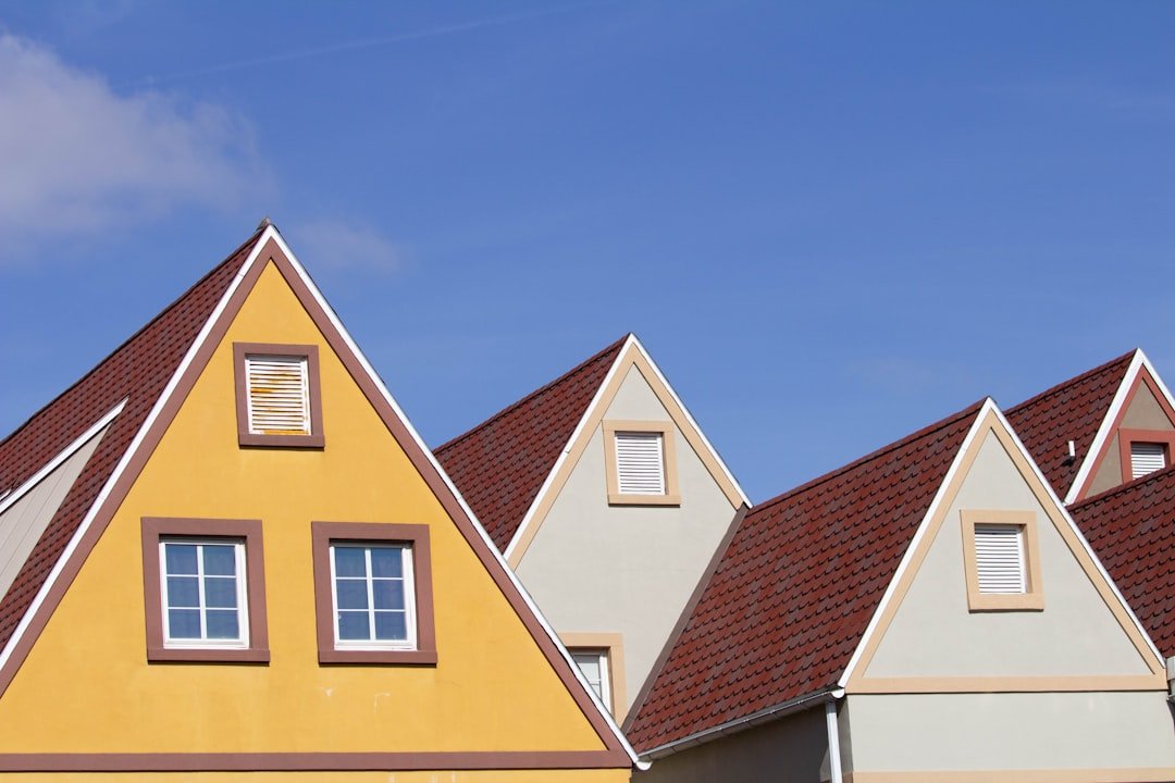 a row of houses with a blue sky in the background