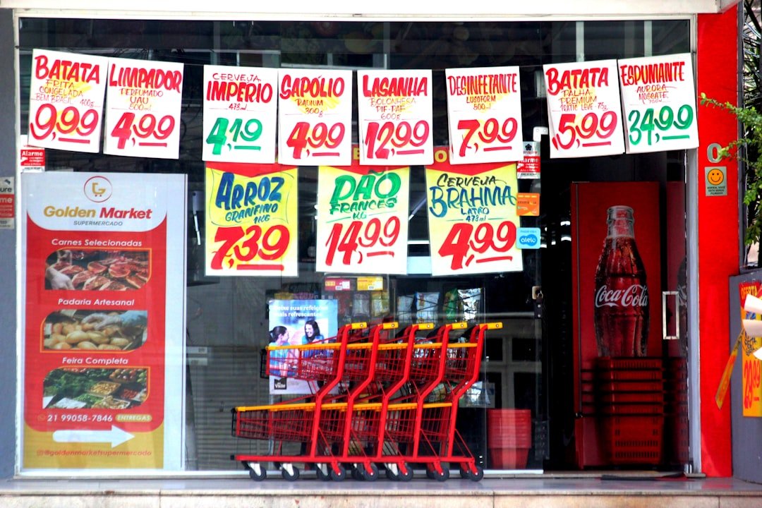 A grocery store window displaying price tags.
