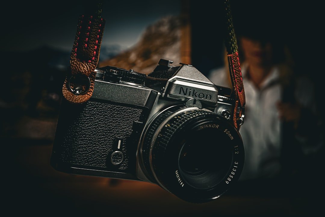 a camera hanging from a rope with a man in the background