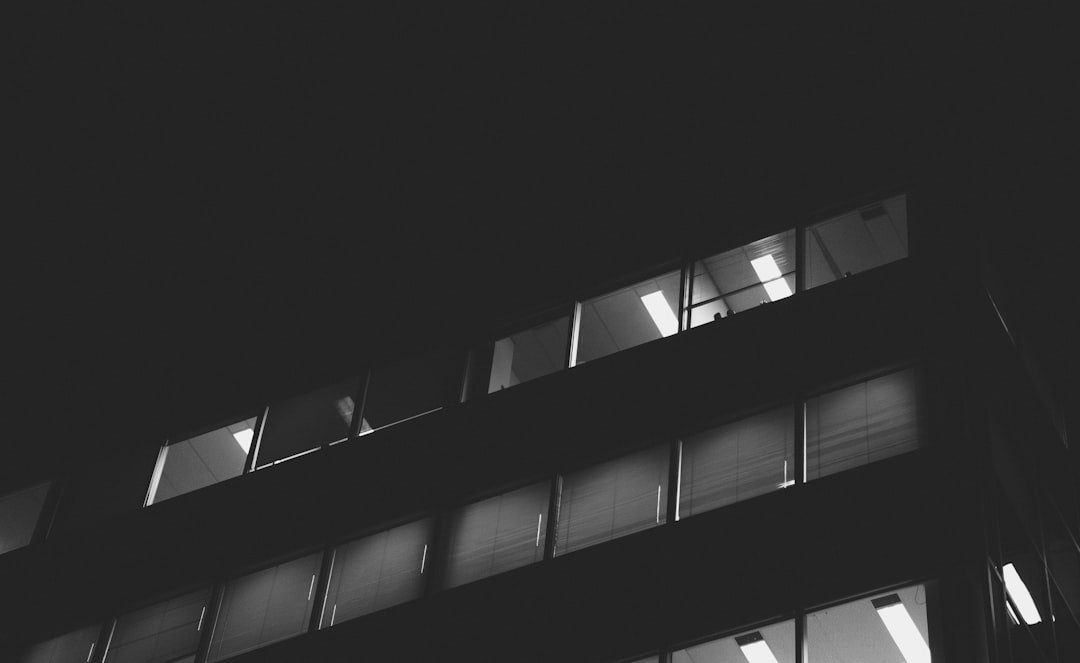 a black and white photo of a building at night