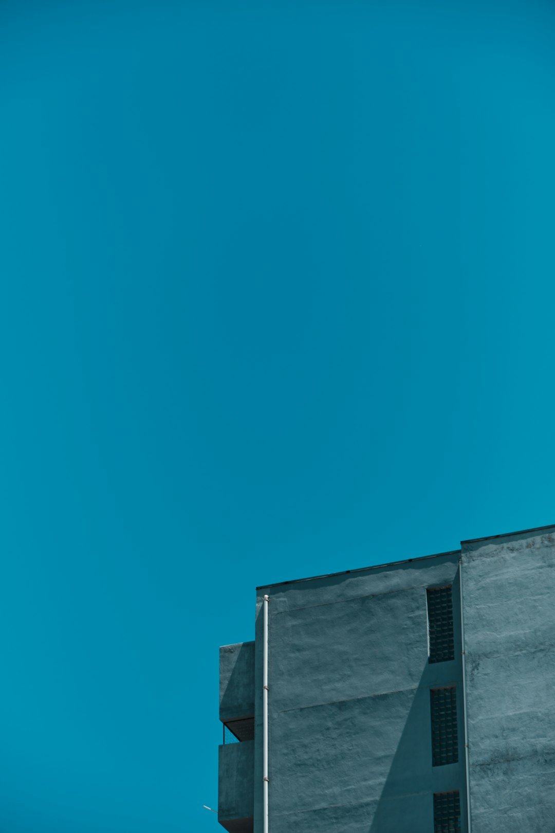 an airplane flying in the sky over a building