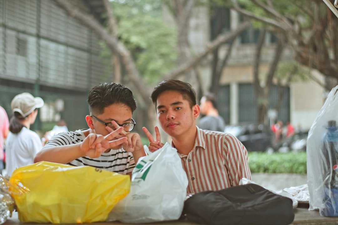 two men doing hand signs