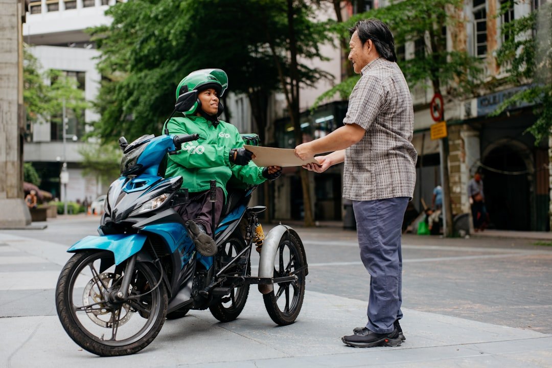 a man standing next to a woman on a motorcycle