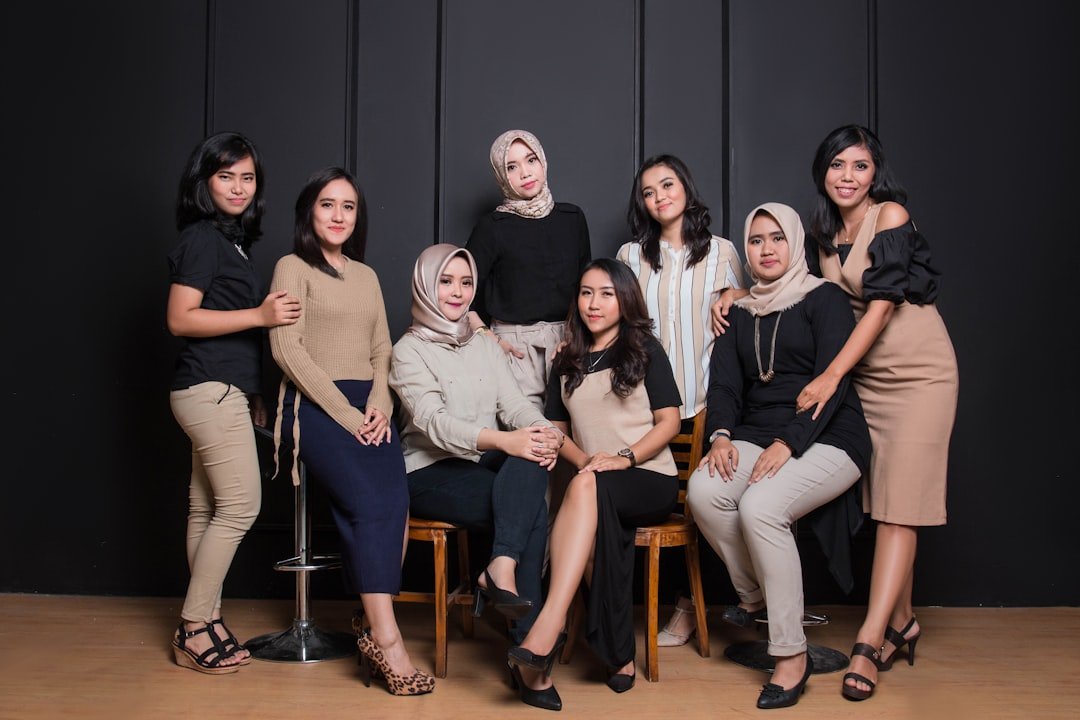 group of women sitting on chair