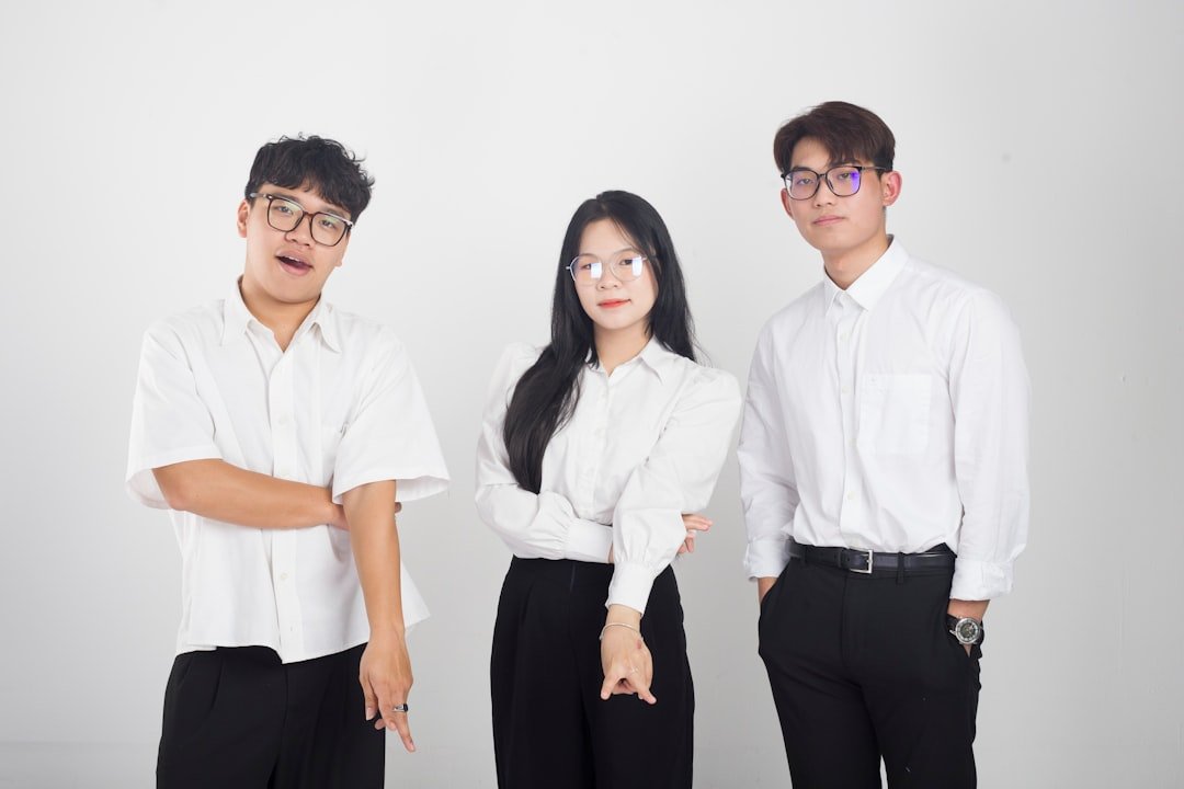 a group of three people standing next to each other