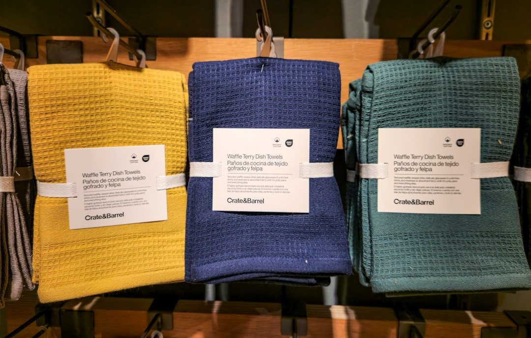A row of towels hanging on a rack in a store
