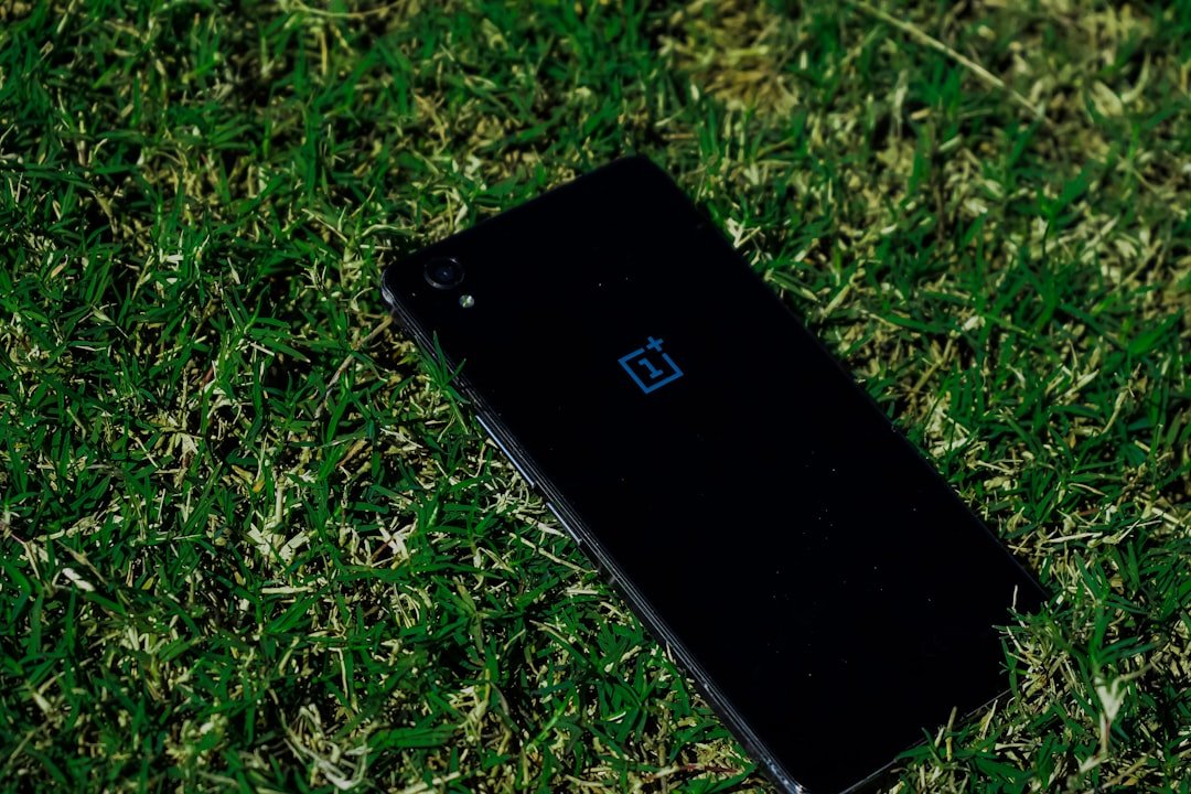 black iphone 5 on green grass