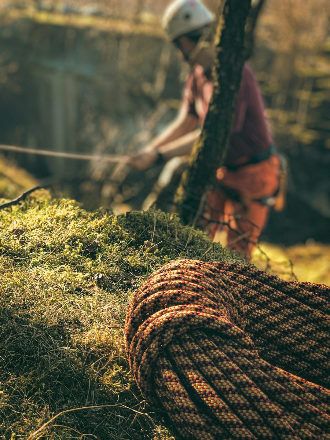 a man riding a bike next to a rope